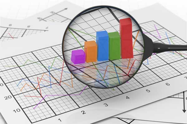 a graph with a magnifying glass representing marketing analytics
